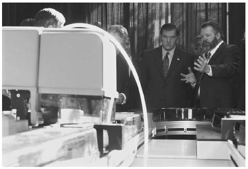 University of Nebraska researchers explain laboratory automation equipment available to analyze bioterrorism agents to the Secretary of the Department of Homeland Security, Tom Ridge, second from right. AP/WIDE WORLD PHOTOS.