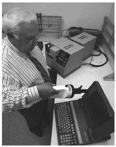 A dust sample is taken from a laptop computer and the particles analyzed for explosives residue by a Barringer explosives detection device. AP/WIDE WORLD PHOTOS.