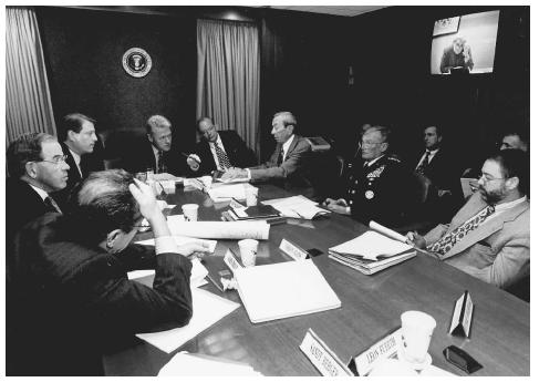 President Bill Clinton, at the head of the table, meets with national security advisors at the White House in November 1995, to discuss the peace agreement in Bosnia. AP/WIDE WORLD PHOTOS.