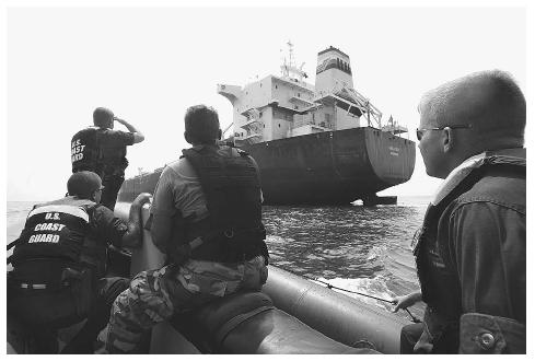 Members of a six-man U.S. Coast Guard law enforcement Tactical Team North, operating from the USS Typhoon, approach the tank vessel Kara Sea, designated a high interest vessel because of its gasoline cargo, in the Chesapeake Bay in August 2002. AP/WIDE WORLD PHOTOS.