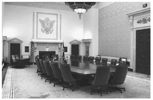 Guided by tradition, Federal Reserve Chairman Alan Greenspan assembles members of the Federal Open Market Committee around this 27-foot magohany table eight times a year to set interest rates. AP/WIDE WORLD PHOTOS.