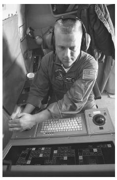 A U.S. Navy aviation systems warfare operator searches for and tracks surface contacts using radar and the Infrared Detection System during a flight mission in support of Operation Enduring freedom in October 2001. AP/WIDE WORLD PHOTOS.