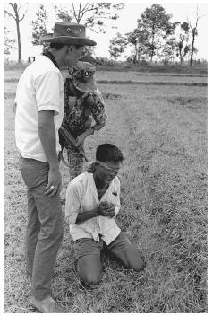 A captured Viet Cong suspect found with a hidden automatic weapon during a "search and seal" operation is interrogated, South Vietnam, 1967. AP/WIDE WORLD PHOTOS.