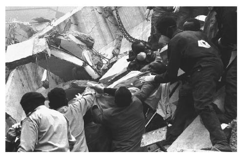 Rescue workers pull an injured man from the ruins of a neighboring building after a powerful blast detonated next to the U.S. Embassy in Nairobi, Kenya, in 1998. Islamist al-Qaeda members were blamed for the explosion, which killed over 200 people and injured over 1,600. AP/WIDE WORLD PHOTOS.