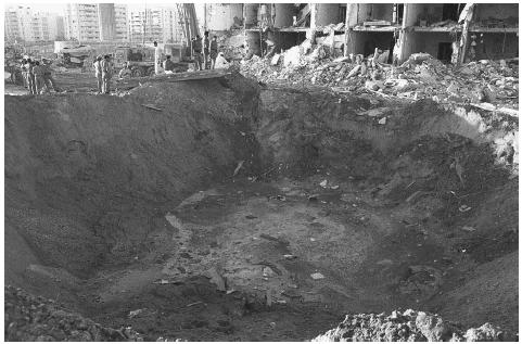 A crater 35 feet deep and 85 feet wide was made by a truck bomb exploded at the Khobar Towers in Dhahran, Saudi Arabia. The bomb killed 19 American servicemen and wounded hundreds more. AP/WIDE WORLD PHOTOS.