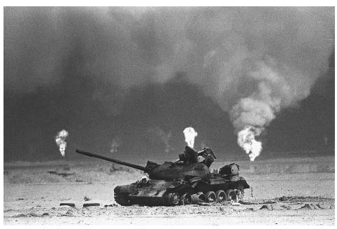 An Iraqi tank rests near a series of oil well fires in northern Kuwait during the 1991 Persian Gulf War. Hundreds of fires burned out of control, casting a pall of toxic smoke over Kuwait before firefighting companies, mostly from the United States, extinguished the last fire months later. AP/WIDE WORLD PHOTOS.