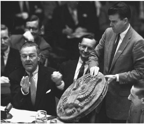 U.S. Ambassador to the United Nations Henry Cabot Lodge, left, complains to the United Nations Security Council in 1960 about a wooden carving of the Great Seal of the Unites States in the office of the U.S. Ambassador in Moscow (shown) that had been implanted with a miniature listening device by the Soviets. AP/WIDE WORLD PHOTOS.