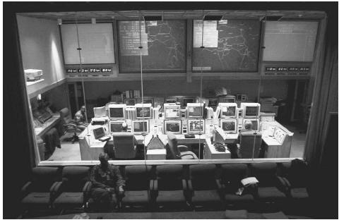 Large computer screens display maps of the globe inside the main command center for the North American Air/Aerospace Defense Command (NORAD) in Cheyenne Mountain Air Station, 1997. AP/WIDE WORLD PHOTOS.