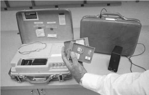 A Nuclear Emergency Search Team (NEST) member shows portable sensing equipment used to detect radioative sources. The briefcase design allows NEST members to carry the sensing device undetected in crowded environments. AP/WIDE WORLD PHOTOS.