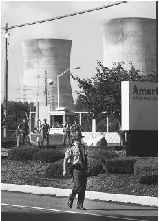 A Pennsylvania State Police officer patrols the entrance of the Three Mile Island nuclear power plant near Harrisburg, Pennsylvania, in July 2002, as security at power plants has been increased since the attacks of September 11, 2001. AP/WIDE WORLD PHOTOS.