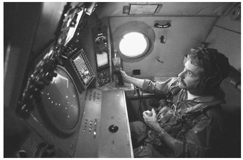 A U.S. Navy aviation systems warfare operator searches for and tracks surface contacts using radar and the Infrared Detection System of his P-3 Orion patrol aircraft during a routine flight in support of Operation Enduring Freedom in October 2001. AP/WIDE WORLD PHOTOS.