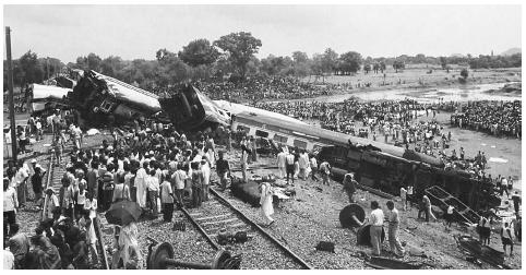 Sabotage is suspected in the September 2002 derailment of an express train on its way from Calcutta to New Delhi in the Indian state of Bihar, leaving one car plunged into a river and two others dangling from a bridge. Fifty people died and 180 were injured. AP/WIDE WORLD PHOTOS.