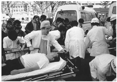 Subway passengers affected by sarin gas planted in central Tokyo subways are carried to the hospital in March 1995. Years after the Aum Shinri cult's terrorist attack in which 11 people were killed and thousands were injured, many victims still suffer physical symptoms from the gas. AP/WIDE WORLD PHOTOS.