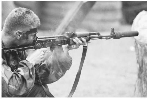 A Hungarian soldier fires an AK-47 style assault rifle equipped with a silencer. ©LEIF SKOOGFORS/CORBIS.