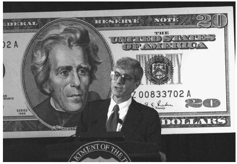 Treasury Secretary Robert Rubin holds a 1998 press confernce to announce the release of a new $20 bill, redesigned to include features that make it more difficult to counterfeit. Anti-counterfeit features will be enhanced every seven to ten years, and will include subtle color changes. AP/WIDE WORLD PHOTOS.