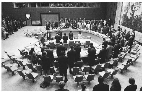 The United Nations Security Council stands to observe a moment of silence during their meeting on September 12, 2001. The council approved a draft resolution condemning the terrorist attack on New York's World Trade Center. ©AFP/CORBIS.